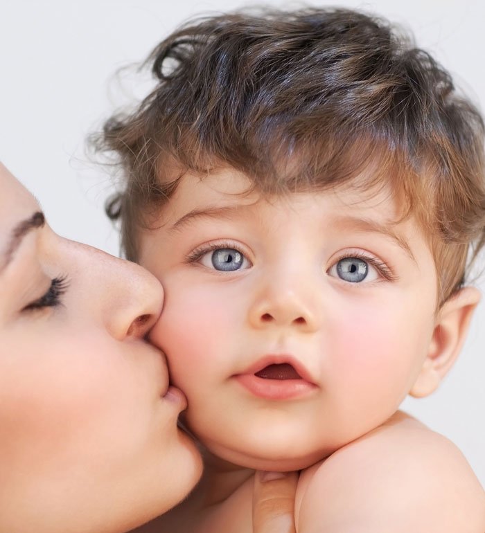 Women kissing her babies cheek