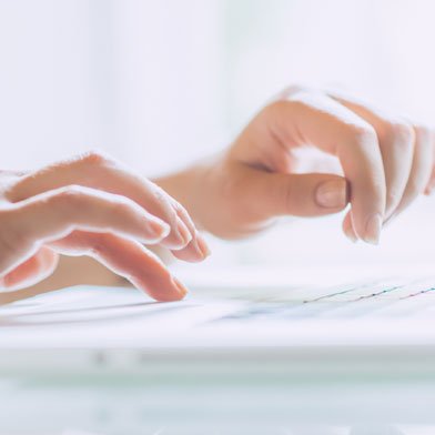 Person typing with beautiful, soft, hands. DU'IT repairs your active hands within 5 days.