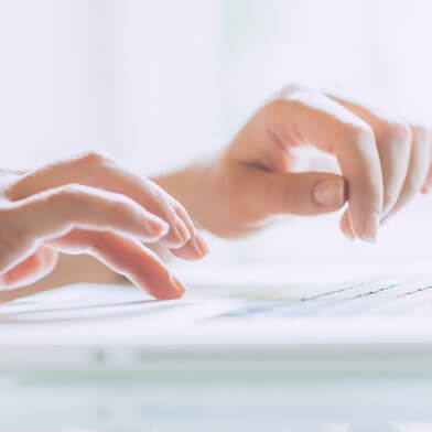 Person typing with beautiful, soft, hands. DU'IT repairs your active hands within 5 days.